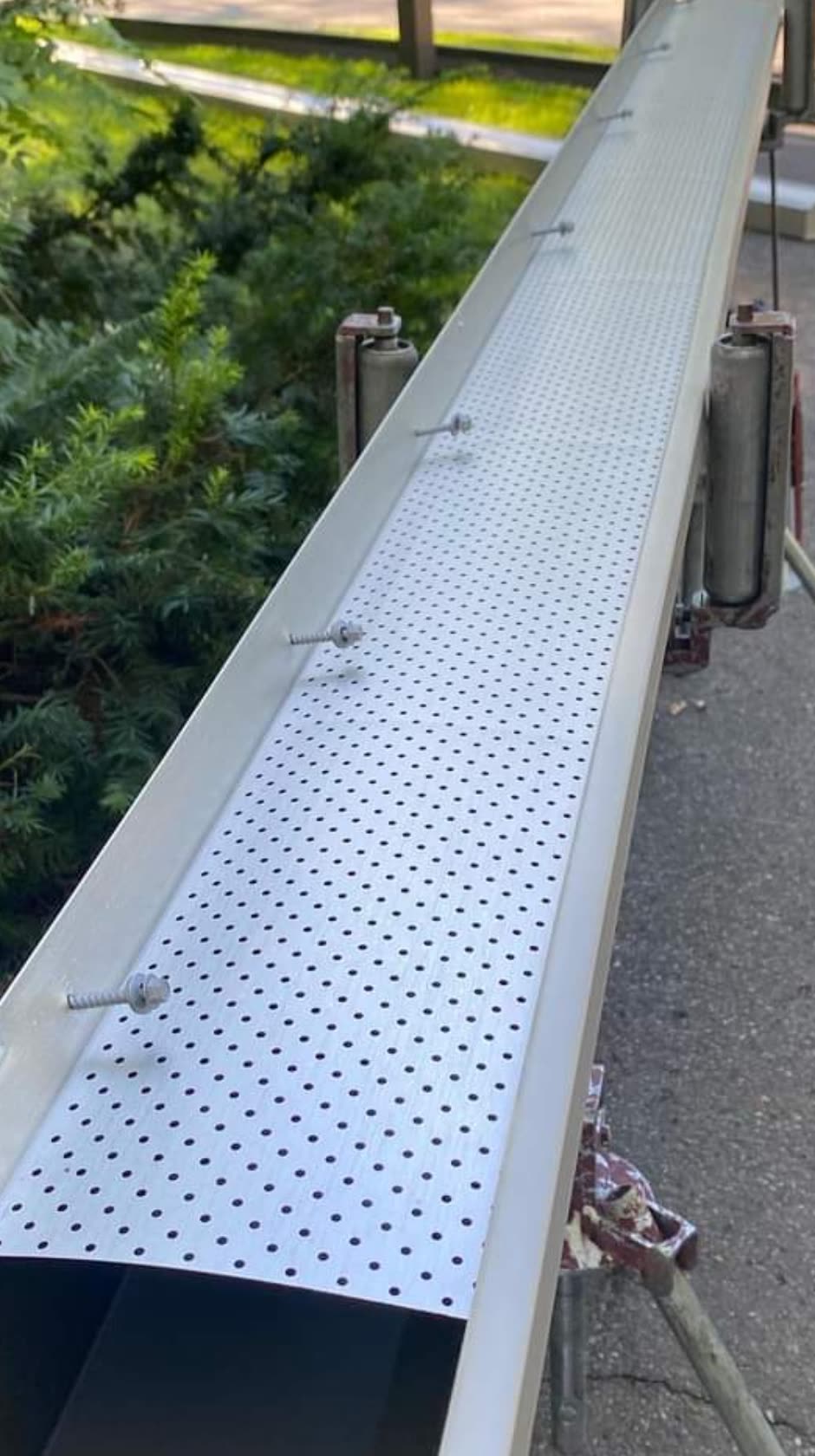 Perforated aluminum leaf guard on a new gutter