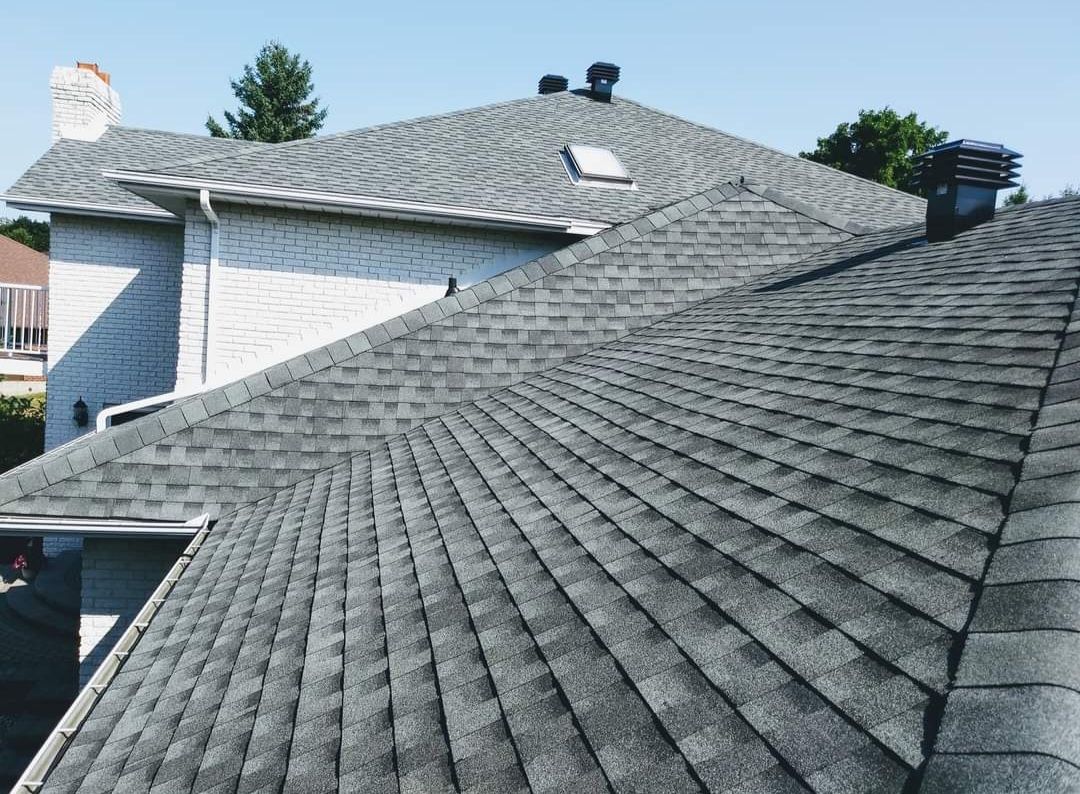 Newly shingled grey roof with vents