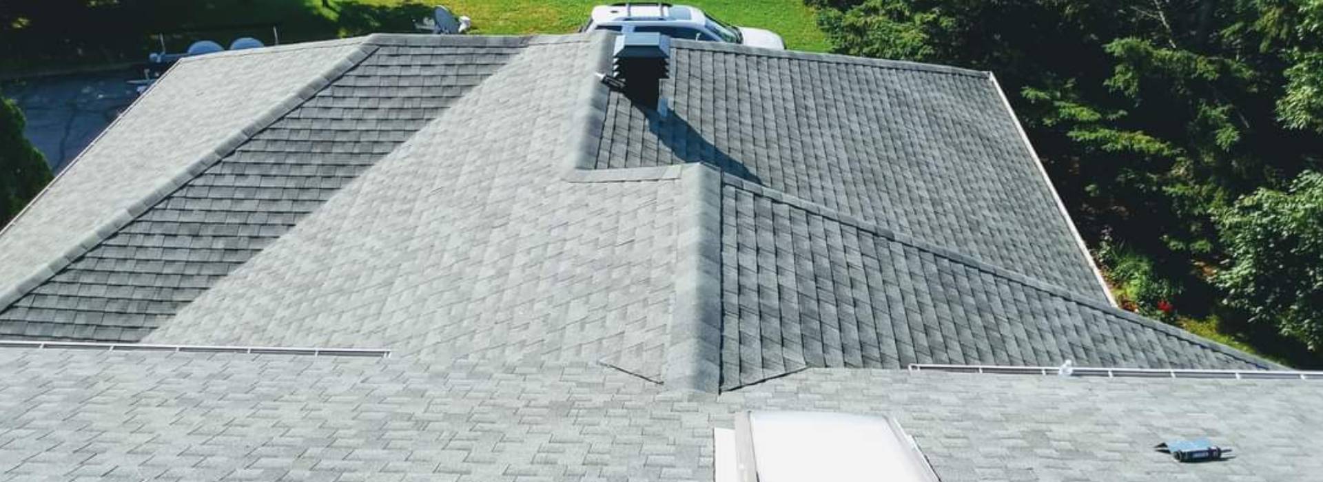 Grey shingle roof with skylights seen from above
